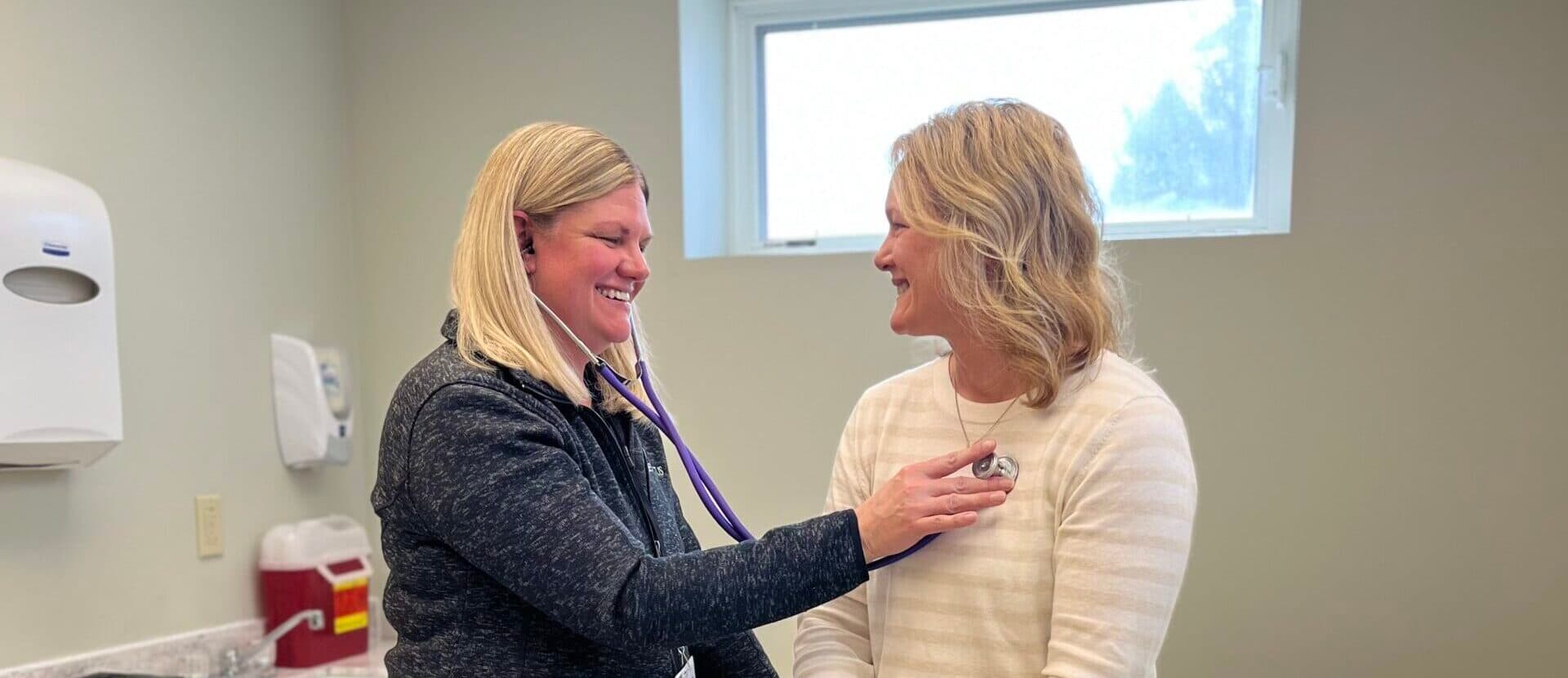 Provider uses a stethoscope on a patient.