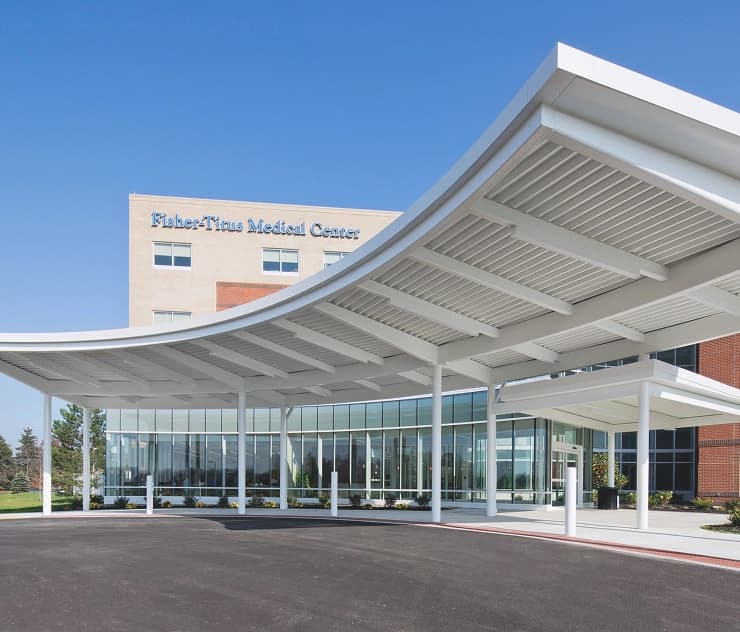 hospital main entrance with modern glasswork and curved overhang