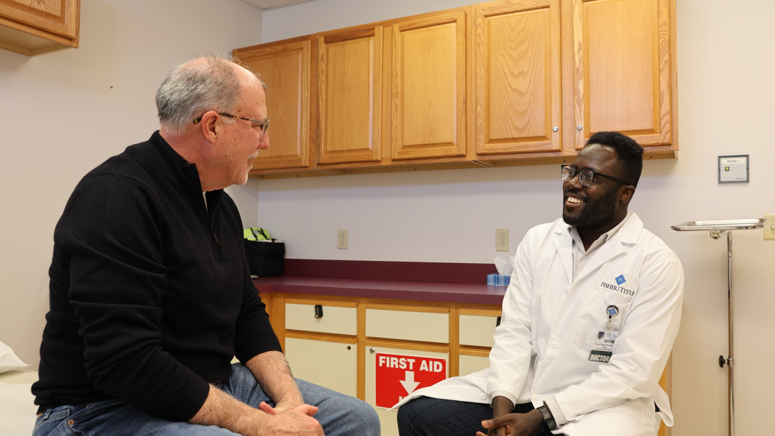 Dr. Kwabena Nkansah-Amankra speaks with a patient.