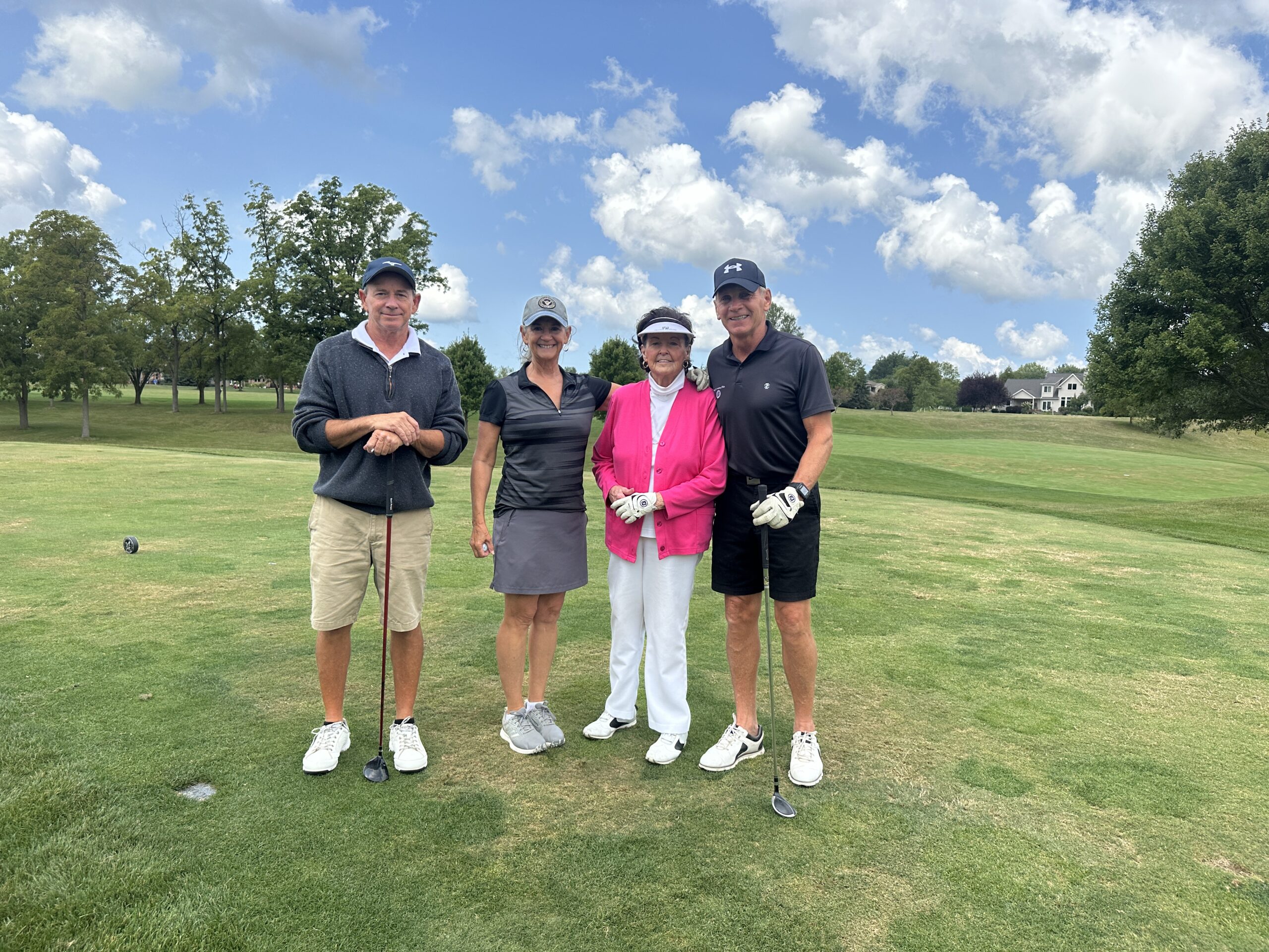 Staff members posing at a golf outing