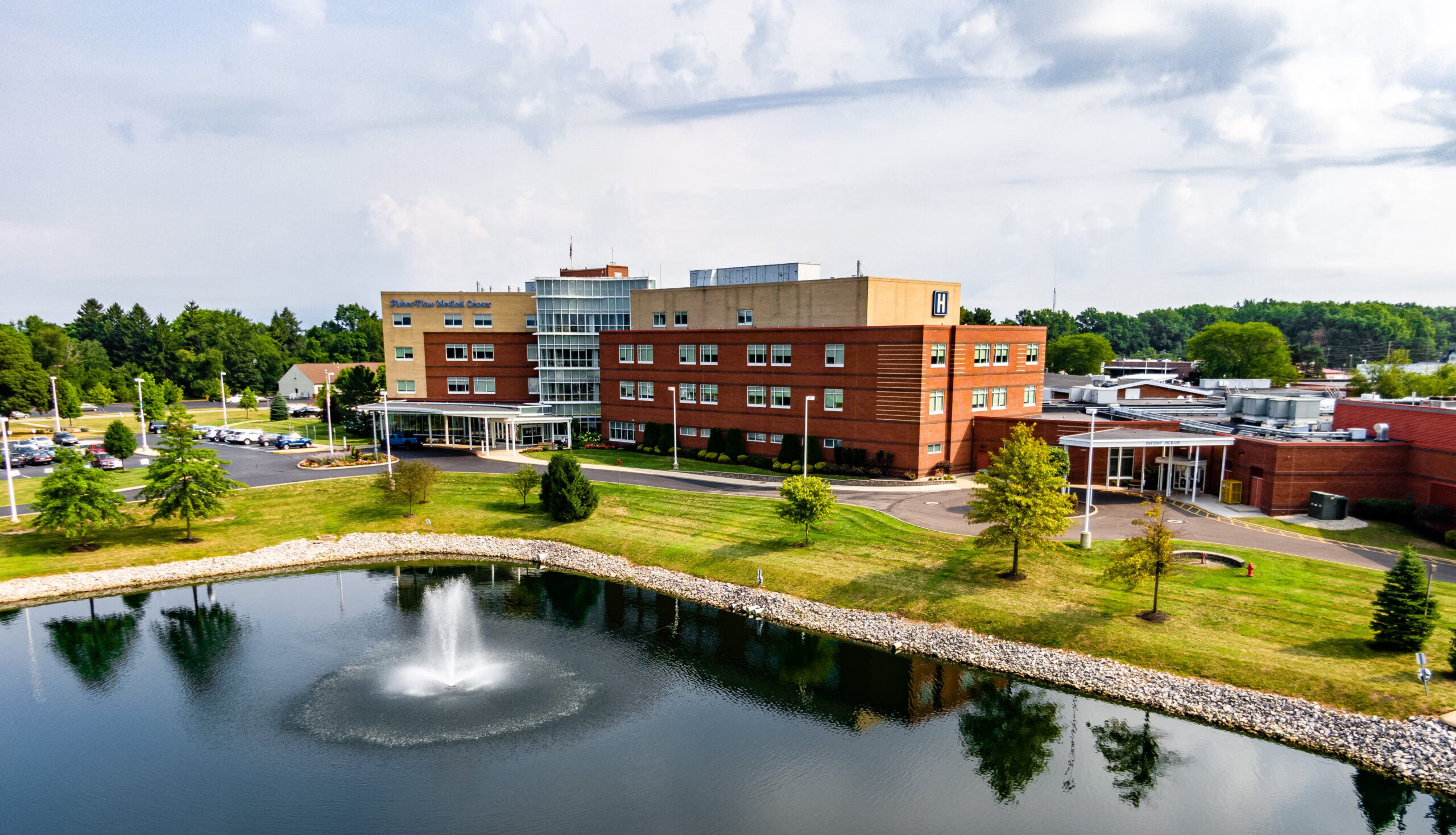 Arial view overlooking a hospital with a pond.