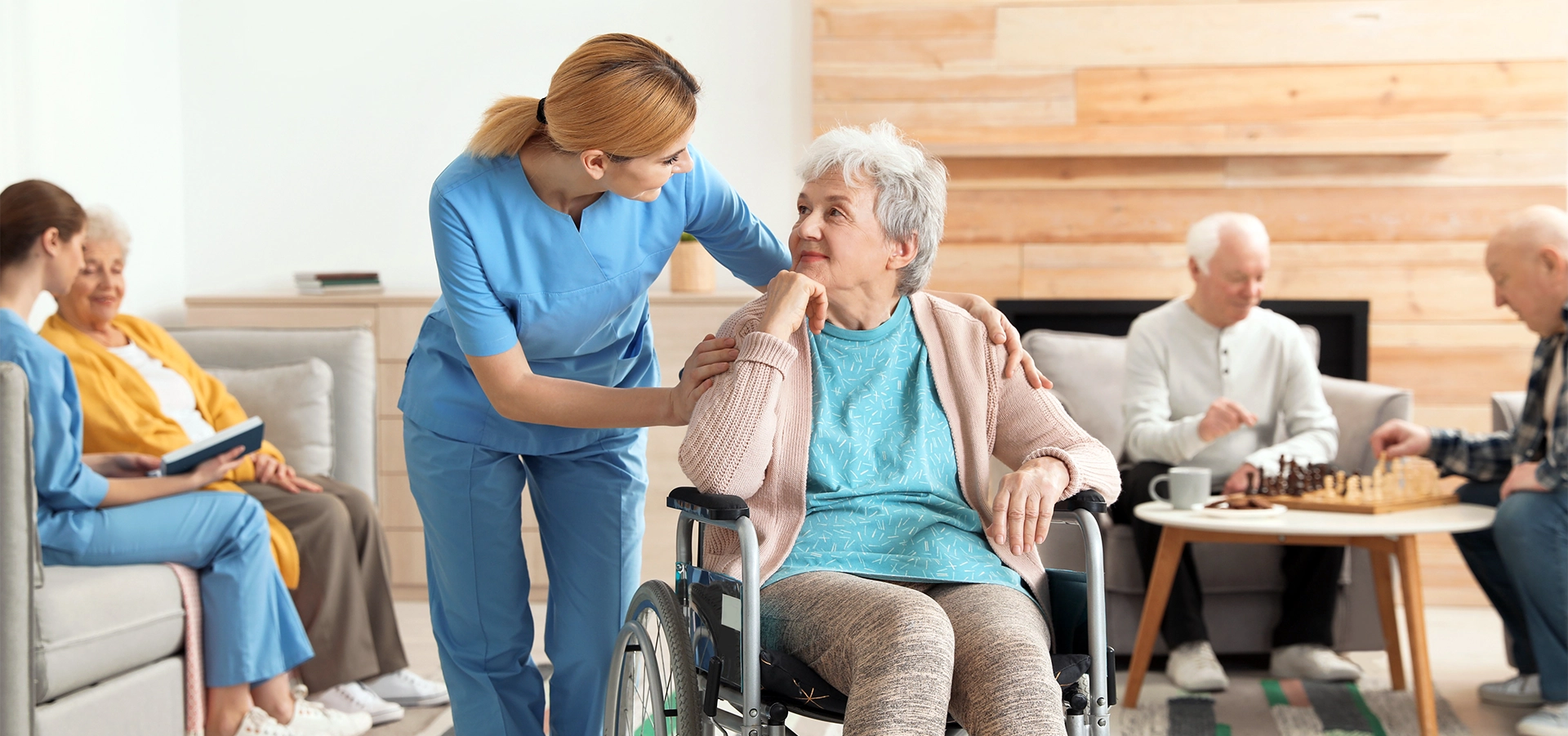 Nurse assisting patient in wheel chair