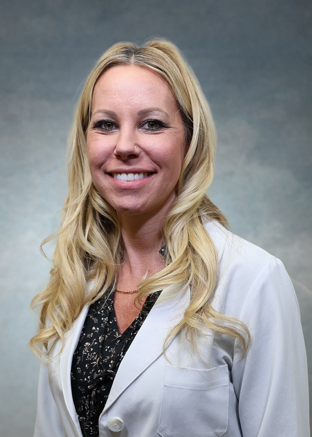 Brandy Morris, CNP, in a white coat.