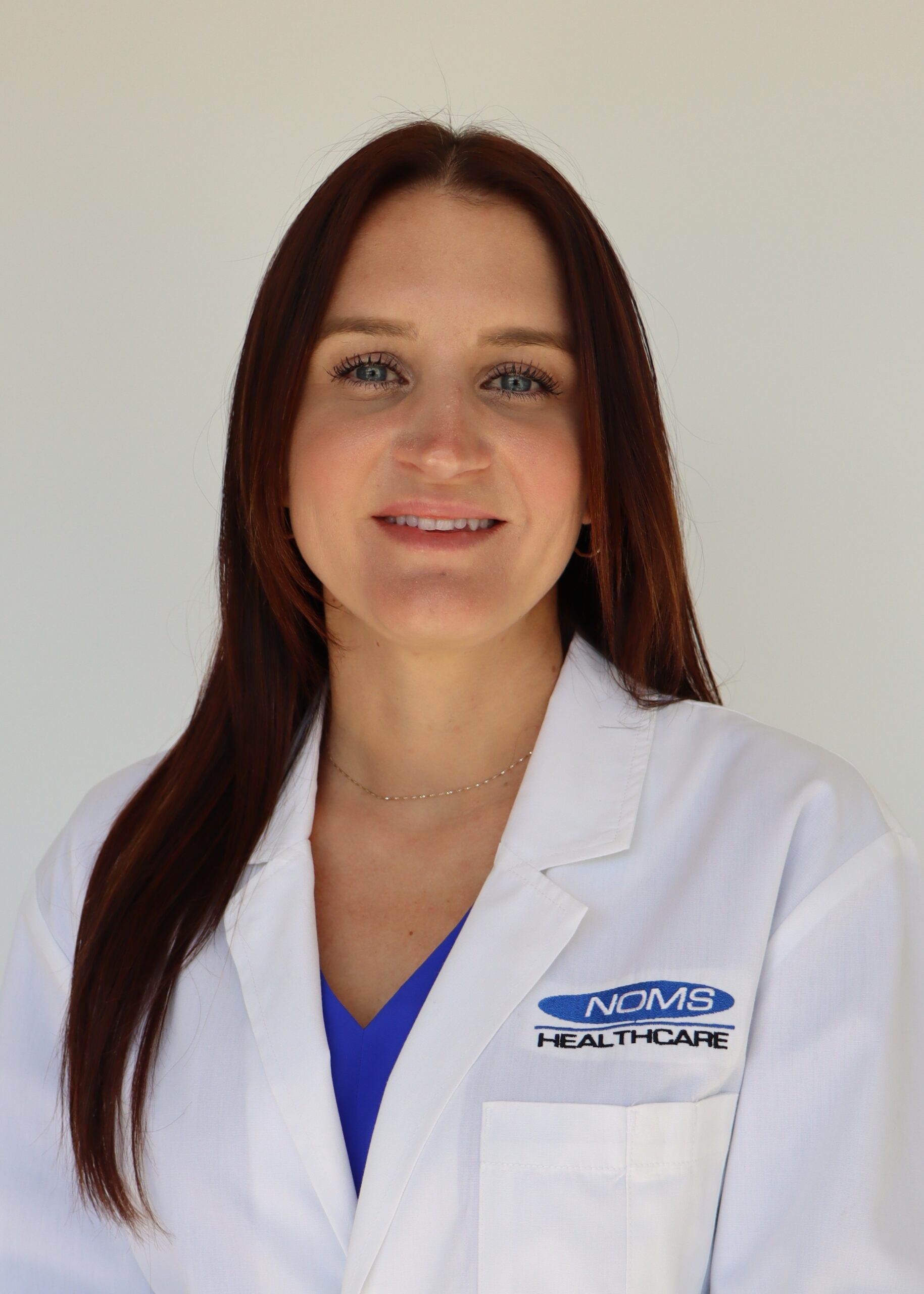 Melissa Woodworth in a white coat.