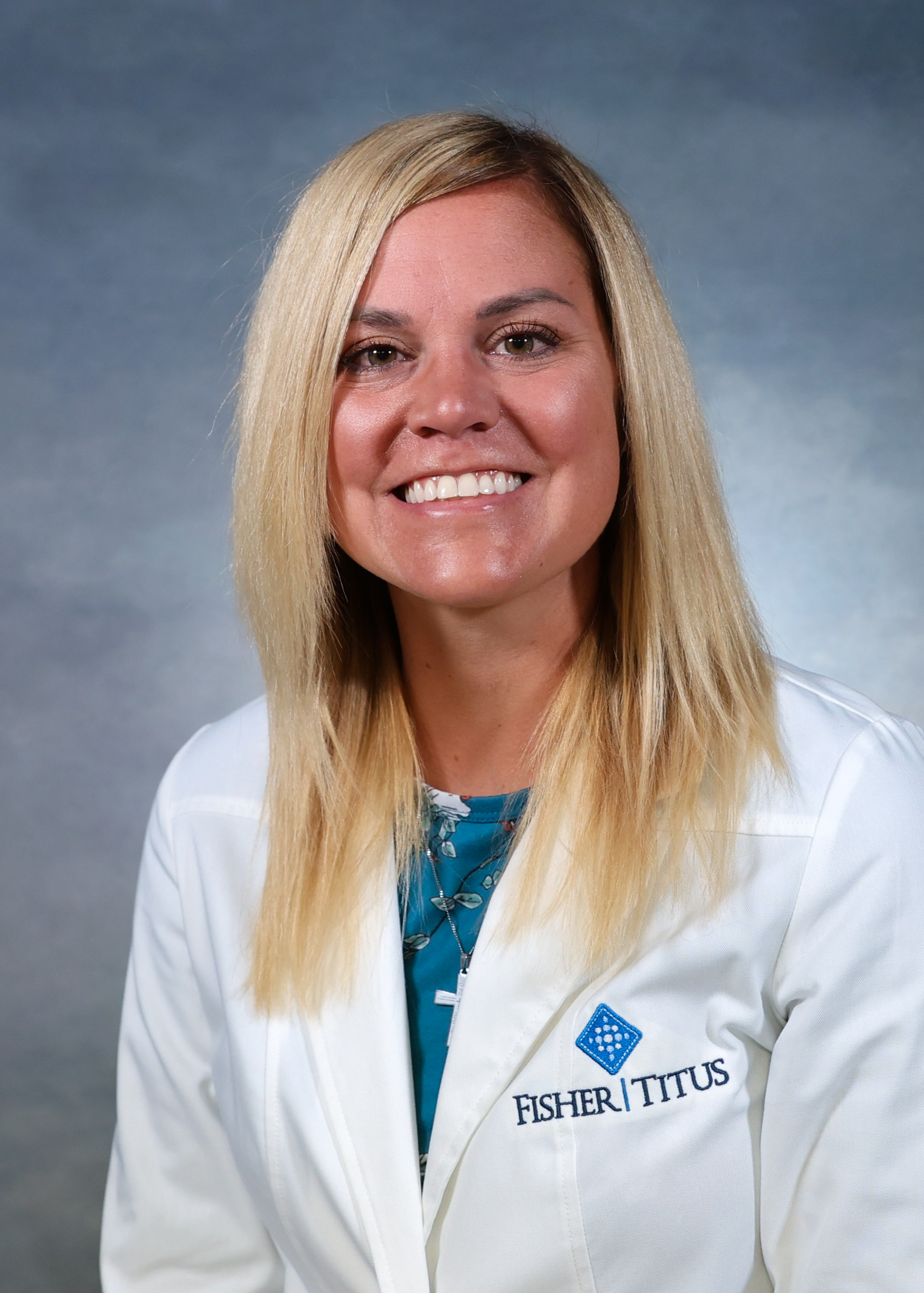 Healthcare provider Audra Mihalic wearing a white Fisher-Titus lab coat, smiling in a professional headshot.